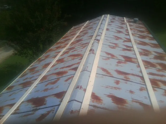Rusted metal roof panels with new wood purlins before replacement — Storm Damage Roof Repair in Aiken by Roofing Brothers