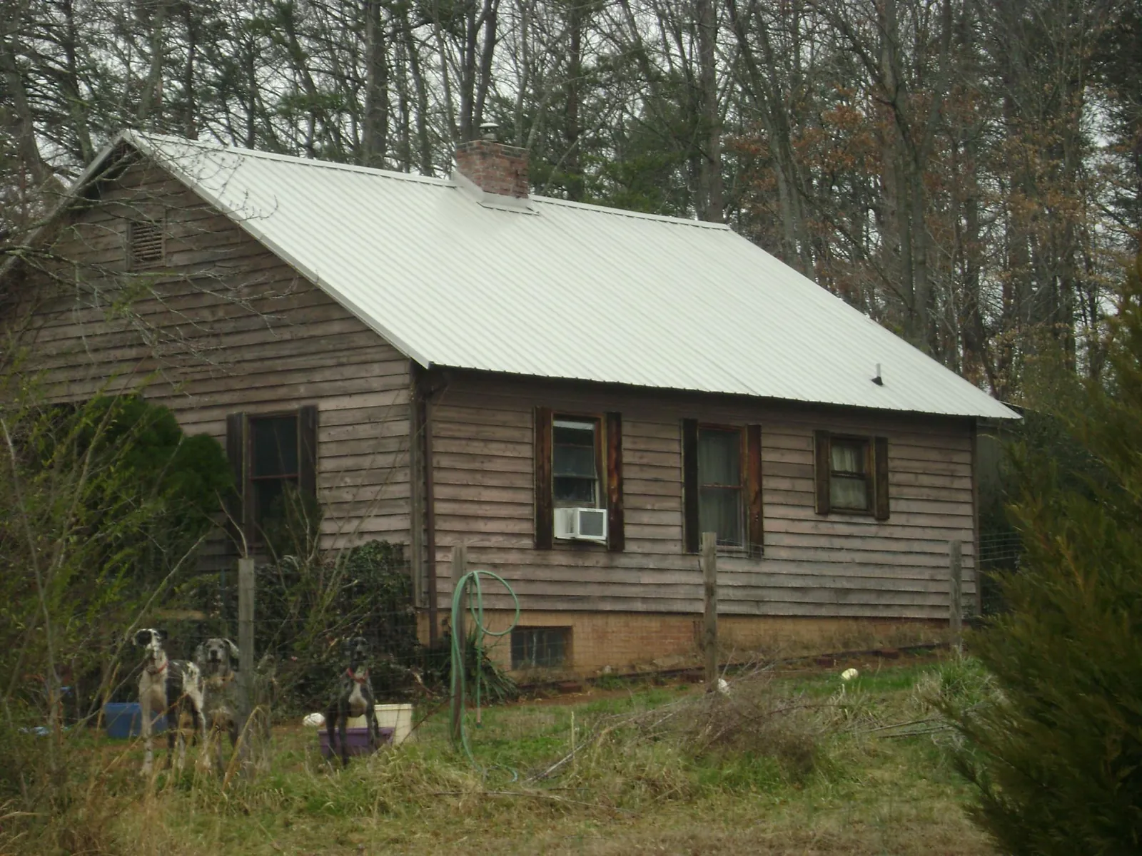White metal roof on an old wood sided farmhouse, from a Metal Roof Installation job in Aiken